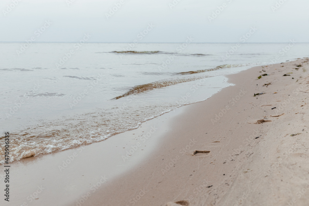 Sea autumn beach with footprints in the sand Sea autumn beach with footprints in the sand