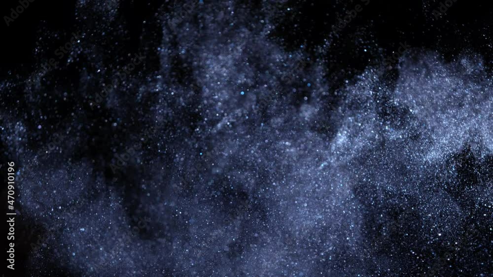Super slow motion of glittering blue particles on black background. Shallow depth of focus. Filmed on high speed cinema camera, 1000 fps. Super slow motion of glittering blue particles on black background. Shallow depth of focus. Filmed on high speed cinema camera, 1000 fps.