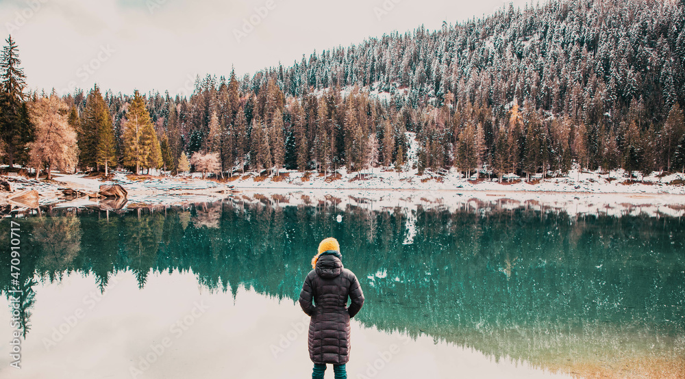 Obraz premium woman watchin amazing turquoise water of Caumasee in winter Switzerland slow travel