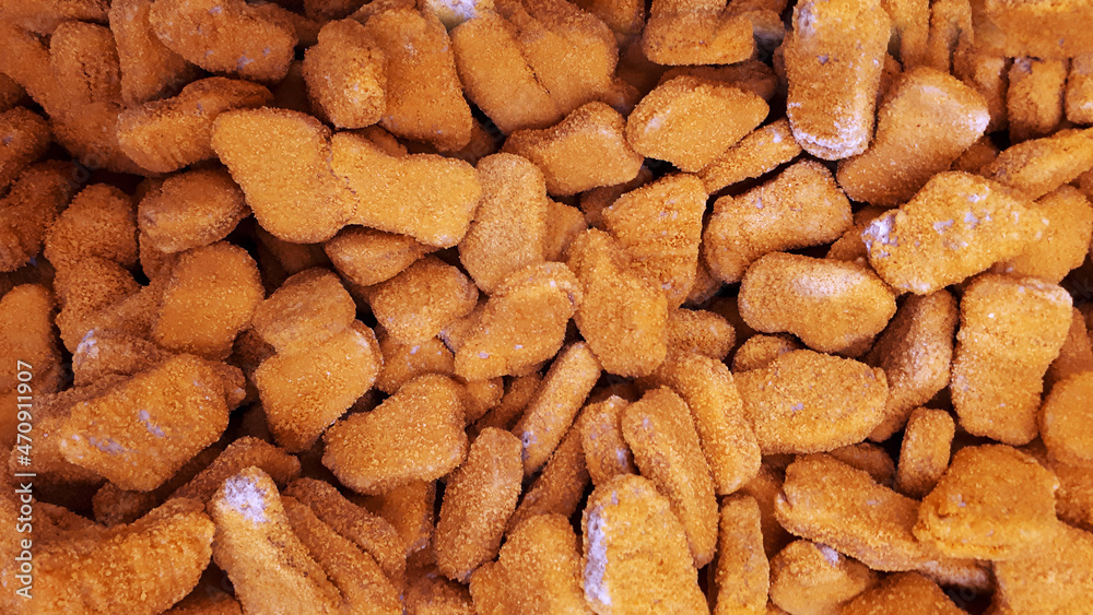 Stack Raw Frozen Chicken Nuggets. Several Chicken Nuggets In Breading Close-Up Stack Raw Frozen Chicken Nuggets. Several Chicken Nuggets In Breading Close-Up
