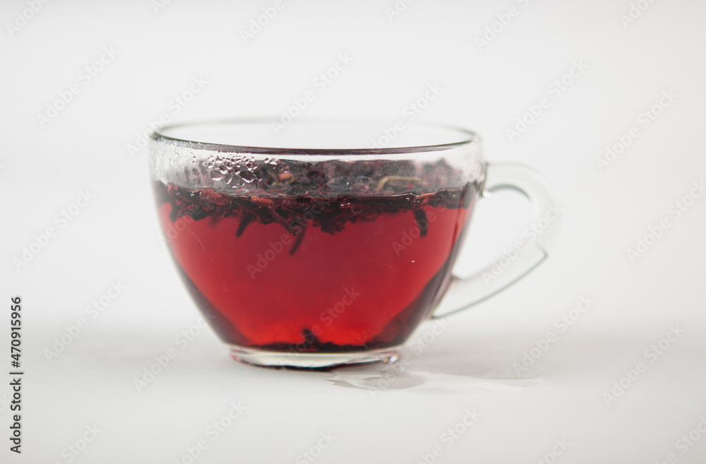 Karkade. Tea drink in a glass. Red liquid in a glass. Dried petals. Hibiscus. Sudanese rose Karkade. Tea drink in a glass. Red liquid in a glass. Dried petals. Hibiscus. Sudanese rose