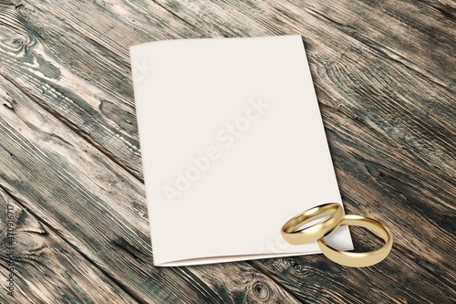 Two wedding rings on a blank marriage contract at a traditional wedding. photo