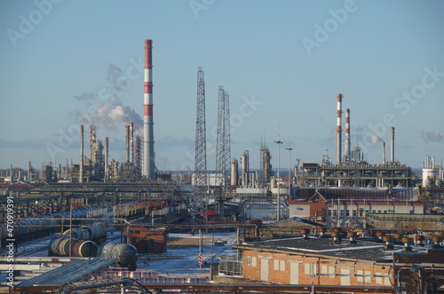 An oil and gas processing plant. Factory buildings, production pipes, railway tanks. Panorama of a large factory.	