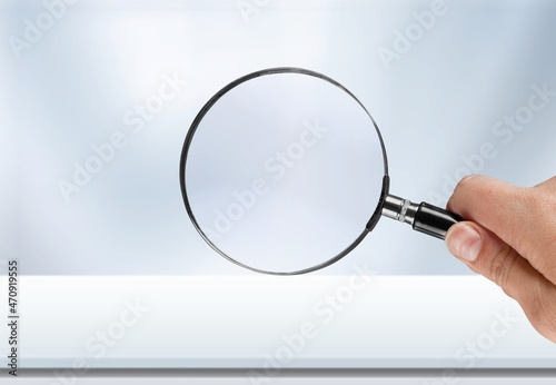 Phrase evidence based practice with a person's hand hold magnifying glass. photo