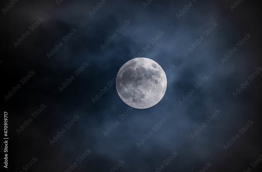 Full moon against the black cloudy night sky Full moon against the black cloudy night sky