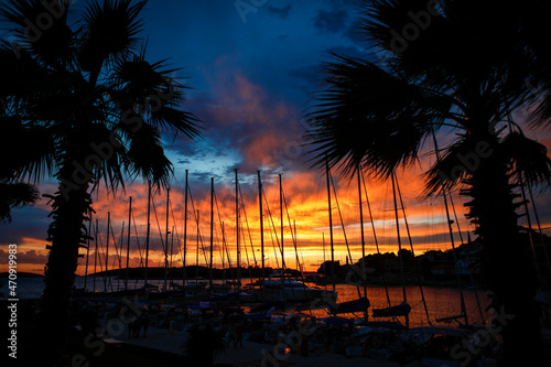 Beautiful sunset under the silhouettes of palms in Croatia