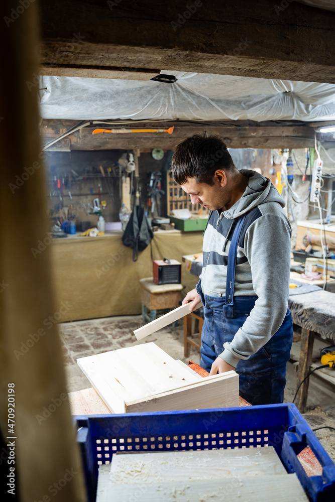 Work in the workshop. Creation of household items from wood. Special clothes and gas mask. Work in the workshop. Creation of household items from wood. Special clothes and gas mask.