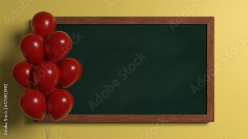 Green chalkboard on yellow clasroom wall and red balloons. 