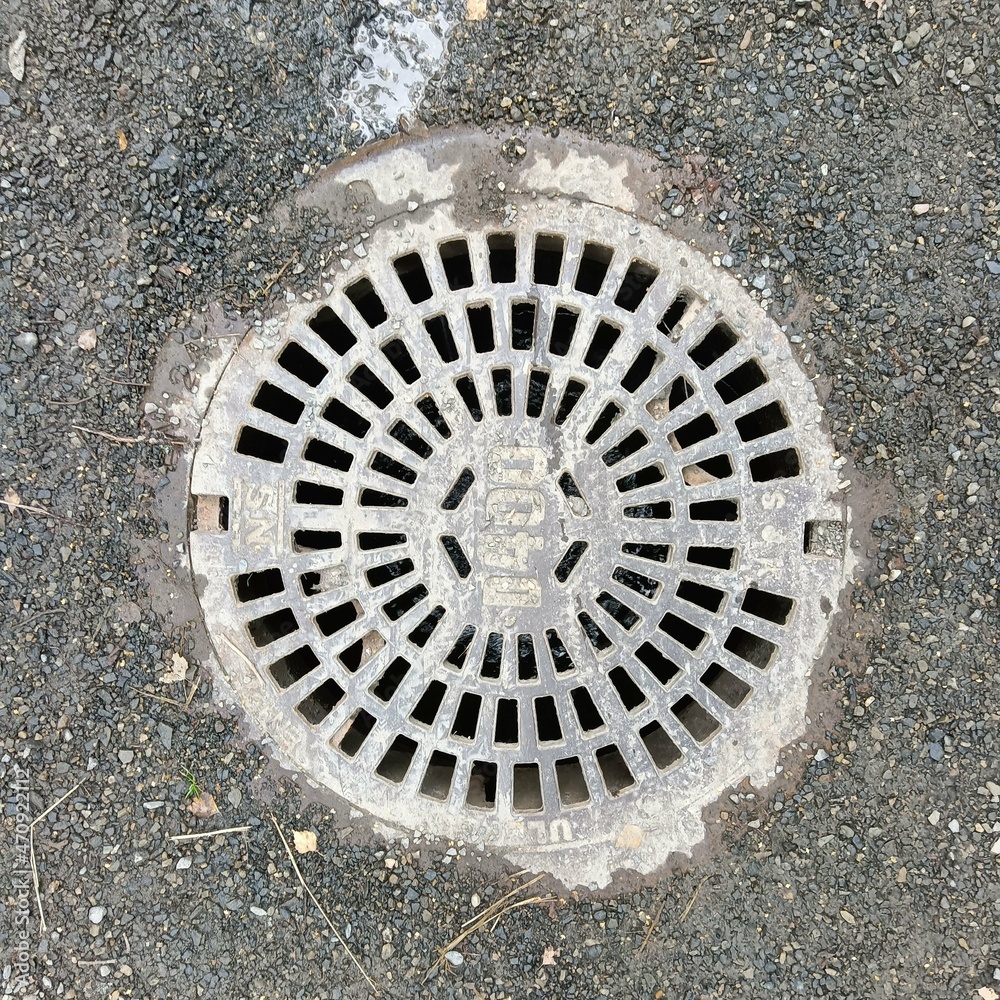  Overhead shot of the metal cover of a sewer in Bilbao.
