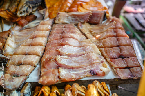Dried and smoked fish at the fish market. Salmon and silver carp. Market "Privoz", Odessa, Ukraine.