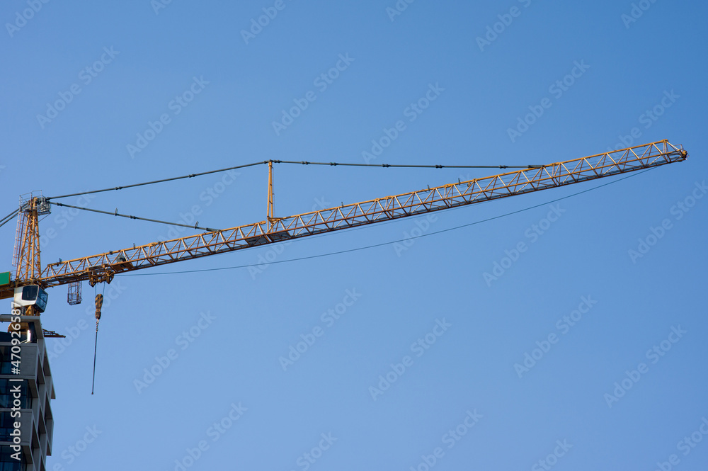 Large yellow crane on top of a building under construction in the Netherlands