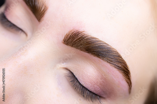 close-up of combed eyebrows with eyebrow paint applied to them