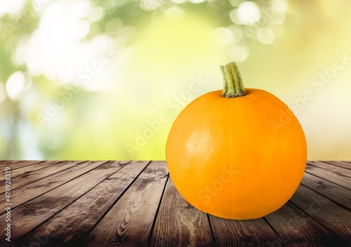 Thanksgiving Day pumpkin on a wooden desk