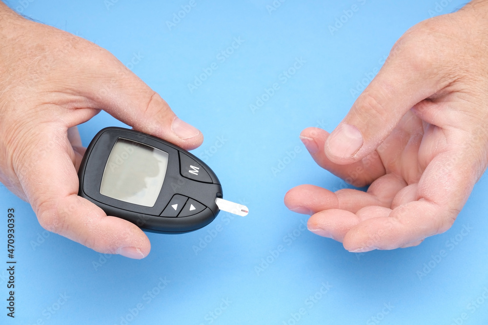 Old man measures blood sugar Old man measures blood sugar