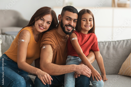 Happy Vaccinated Arab Family Showing Adhesive Bandage After Receiving Injection