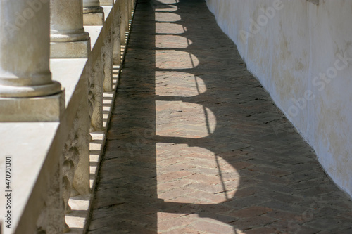 Sunny building corridor colonnade shadow pattern