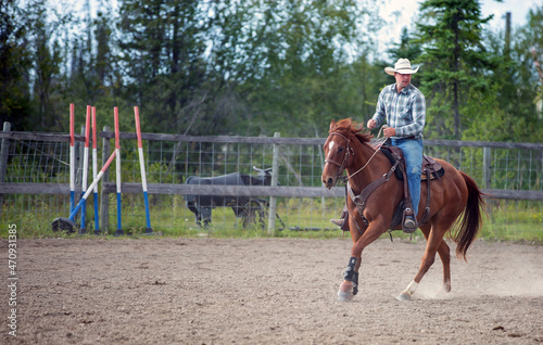 Cowboy riding a horse in Golden British Columbia Canada 