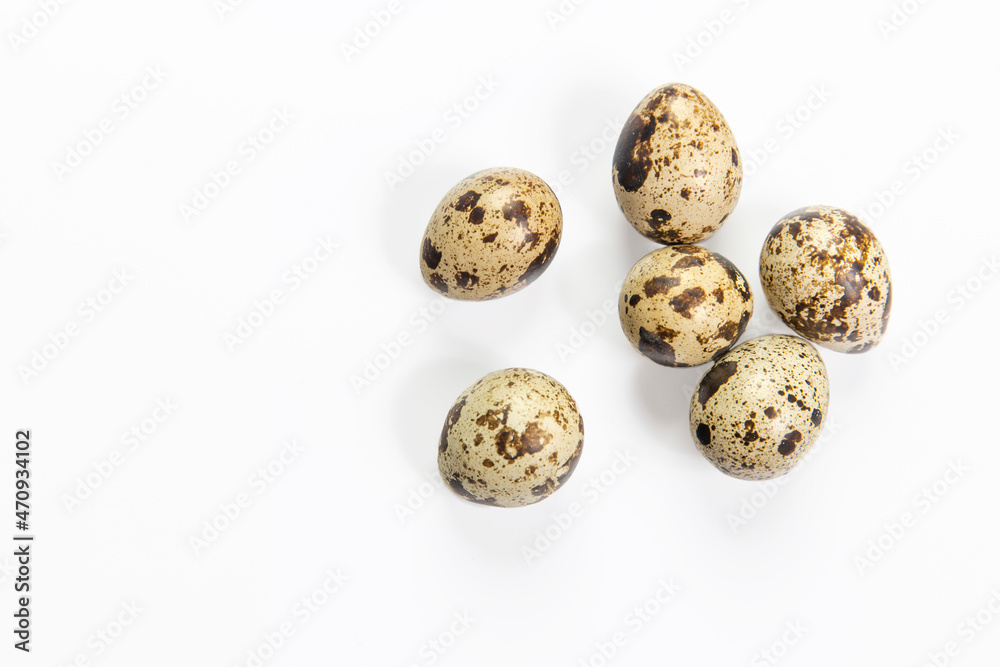 Rustic quail eggs are isolated on white. Copy space. Place for text