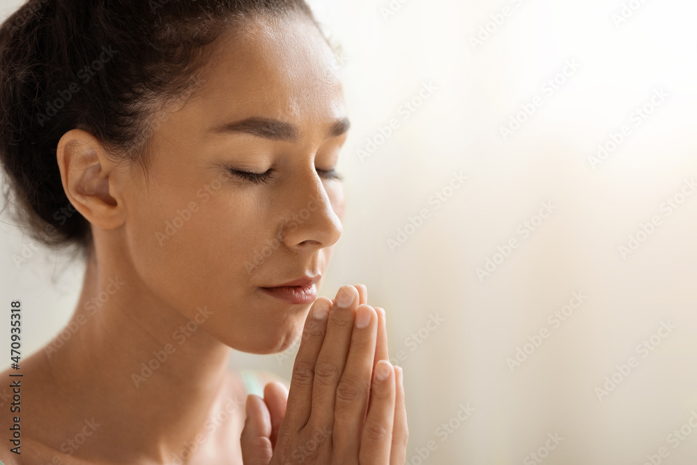 Portrait Of Calm Brunette Woman Praying Or Meditating With Closed Eyes