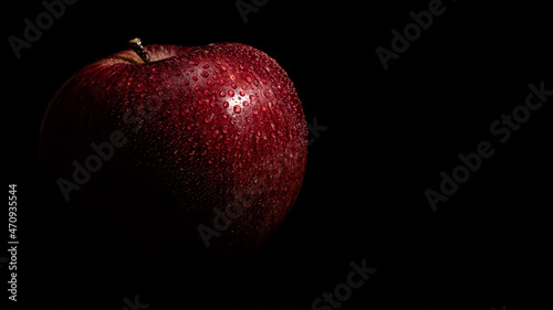 red apple on black background