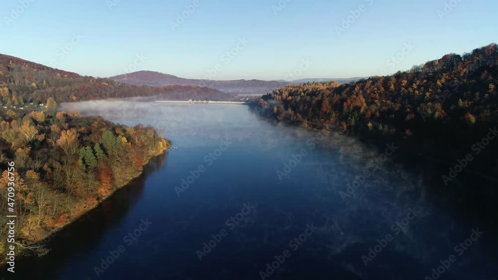 Aerial view of lake, dam and mountains at fall. Aerial view of beautiful colorful fall landscape. Autumn in mountains, epic aerial vista.
Aerial view of lake, dam and mountains at fall. Aerial view of beautiful colorful fall landscape. Autumn in mountains, epic aerial vista.