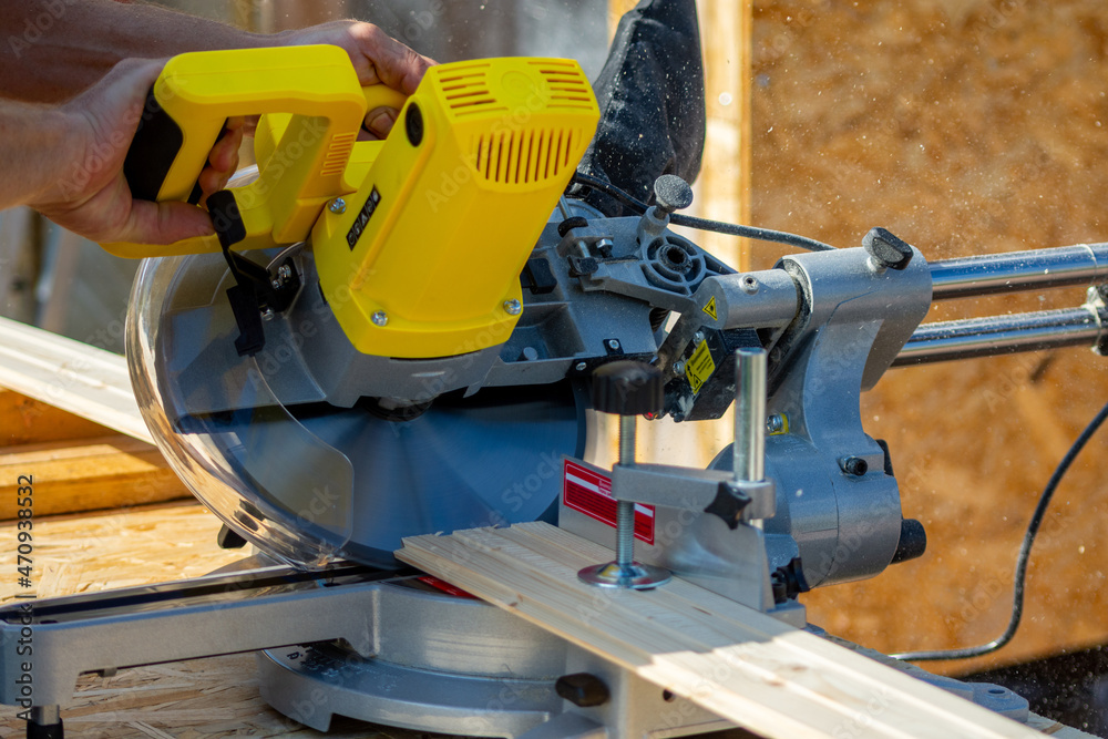 Sawing a board with a miter saw Sawing a board with a miter saw