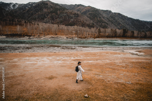 Female Traveler near river Looking at the Golden Autumn in Altai Mountains  Siberia  Russia.