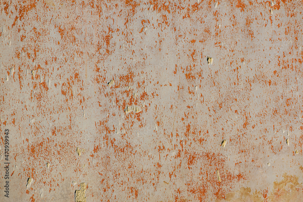 old plastered wall with stains of orange color