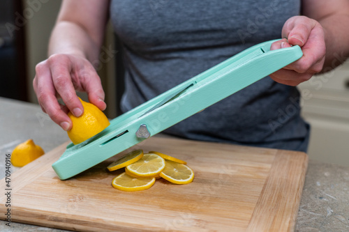 Woman slicing on a mandolin 