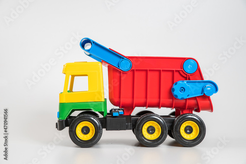 Multi-colored plastic children's toy cars on a white background. Truck. © baxys