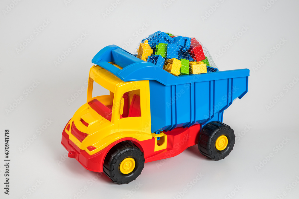Multi-colored plastic children's toy cars on a white background. Multi-colored plastic children's toy cars on a white background.