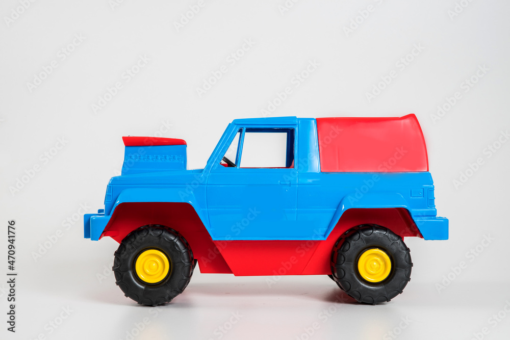 Multi-colored plastic children's toy cars on a white background. Multi-colored plastic children's toy cars on a white background.