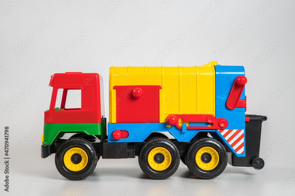 Naklejka premium Multi-colored plastic children's toy cars on a white background.
