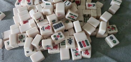 Mixed and scattered different mahjong tiles.