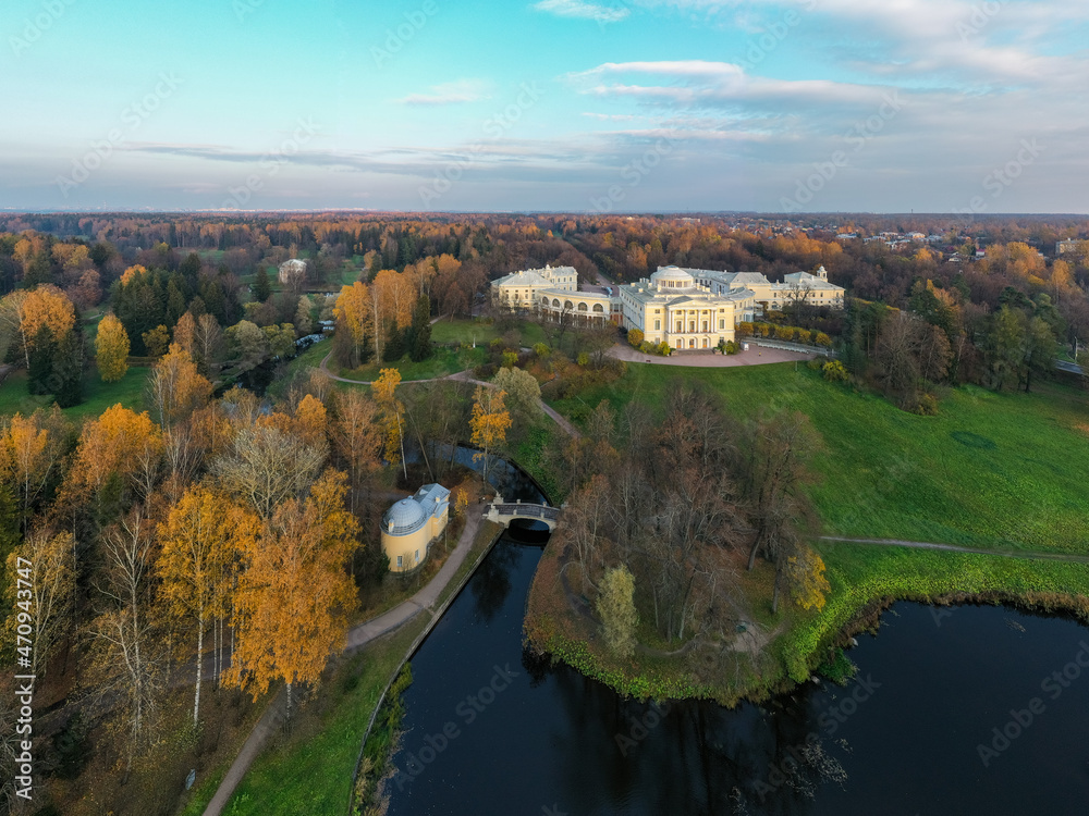 Panoramic aerial view of the Pavlovsk Park and the Pavlovsk Palace on an autumn evening.Bright autumn landscape, Slavyanka river,centaur bridge. A suburb of St. Petersburg.