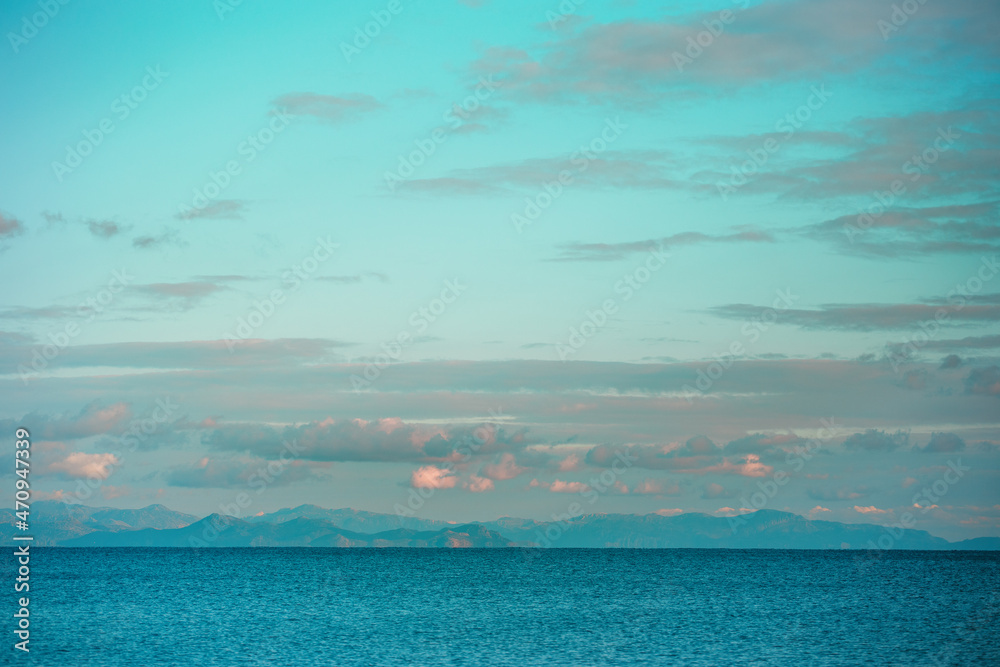 Beautiful seascape, the sun sets behind the mountains Beautiful seascape, the sun sets behind the mountains