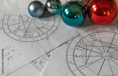 Astrological natal charts with Christmas balls in the background