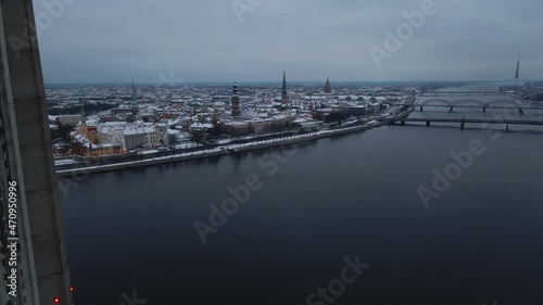 Aerial revealing shot of gloomy winter city of Riga, Latvia through Vansu bridge photo