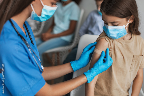 Preteen Girl Getting Vaccinated Against Covid-19 With Vaccine In Clinic photo