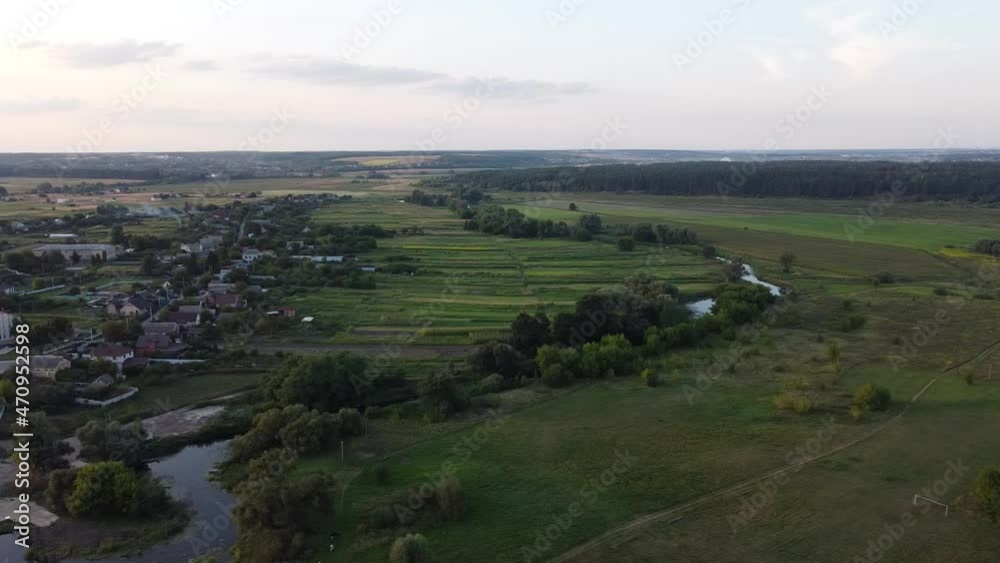 Panorama view of the countryside in the evening. Aerials of the countryside nature. Drone high video of the valley. Forest on the horizon. Harmony and meditation of the summer golden hour. Panorama view of the countryside in the evening. Aerials of the countryside nature. Drone high video of the valley. Forest on the horizon. Harmony and meditation of the summer golden hour.