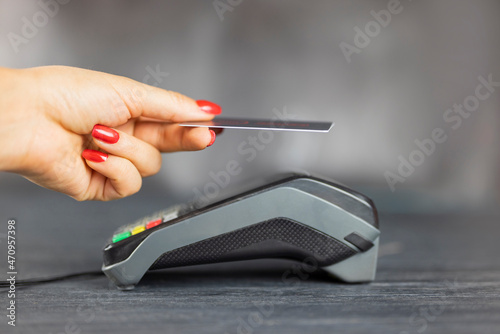 Canvas Print the girl uses the terminal to pay for cashless payments using the bank card syst