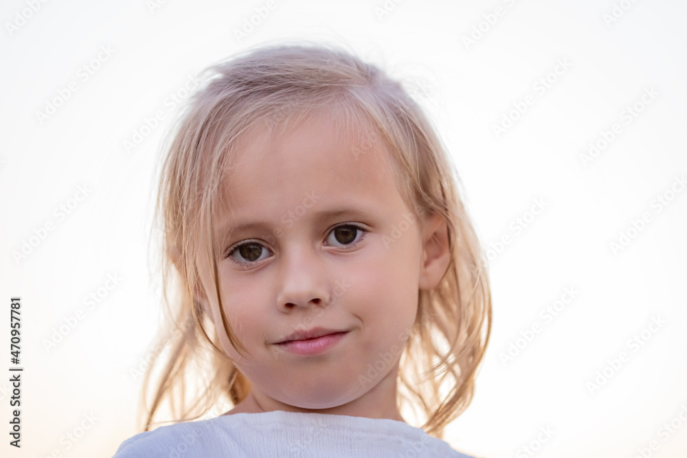 Close up view of little caucasian child girl in white dress posing Close up view of little caucasian child girl in white dress posing