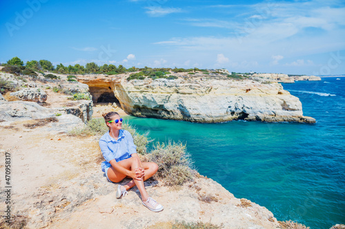 Girl looking out on the ocean. Lagos, Algarve Coast, Portugal