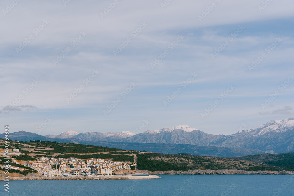 Residential complex in the Lustica bay with mountains in the background. Montenegro