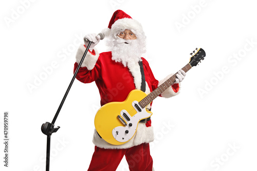 Santa claus playing an electirc guitar and singing on a microphone