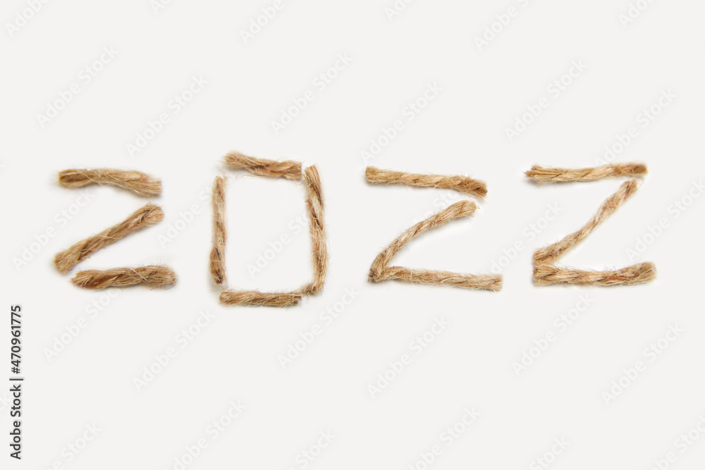 Happy New year 2022. New Year Concept welcoming New Year 2022 written by craft rope or jute on white background. Close-up. Two thousand twenty two Happy New year 2022. New Year Concept welcoming New Year 2022 written by craft rope or jute on white background. Close-up. Two thousand twenty two