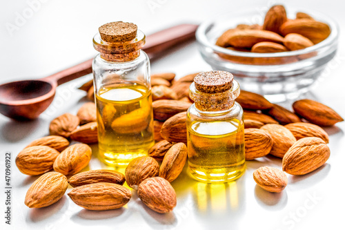 organic cosmetic with almond extract on table background