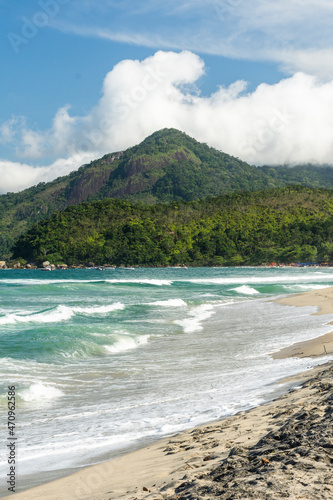 Beautiful view to green rainforest and blue water wild beach photo