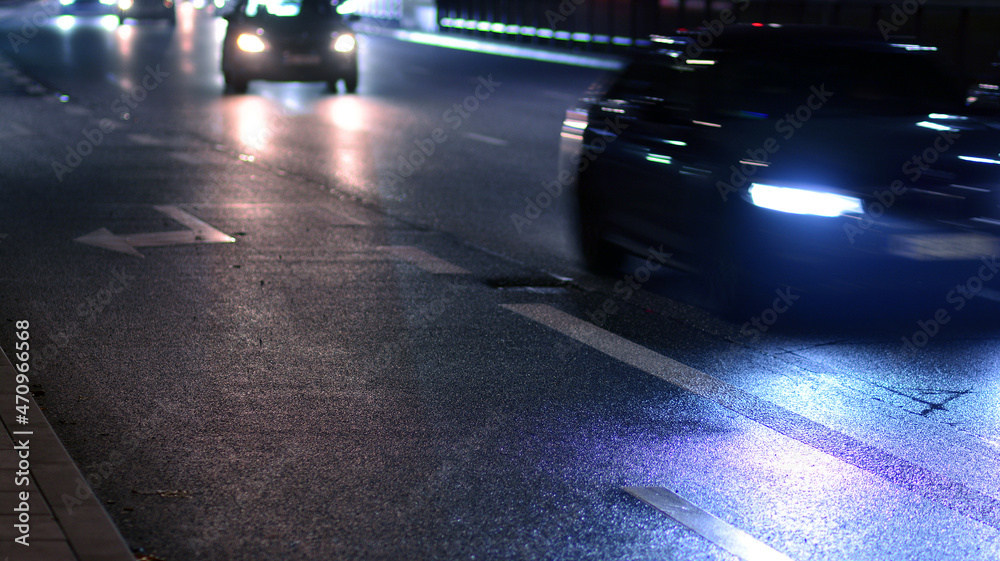 Automobile lights. Night time image of traffic on road with moving cars. 