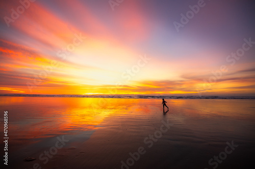 Kid running at the beach during sunset
